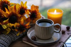 Coffee with candle and flowers